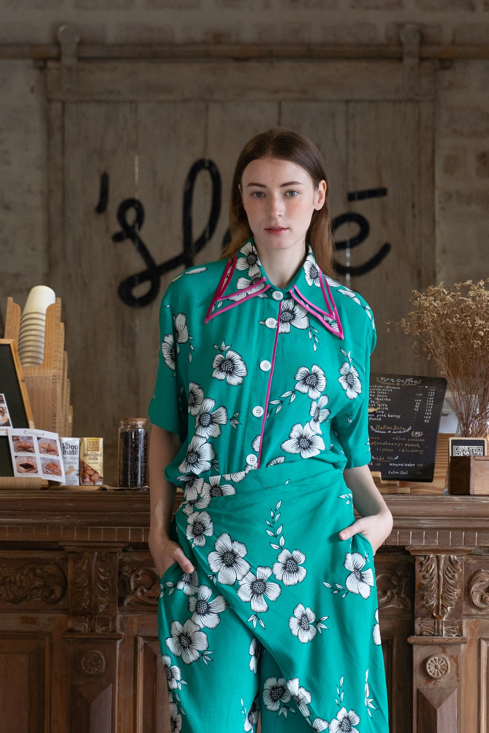 POYA green floral shirt and pants set at cafe