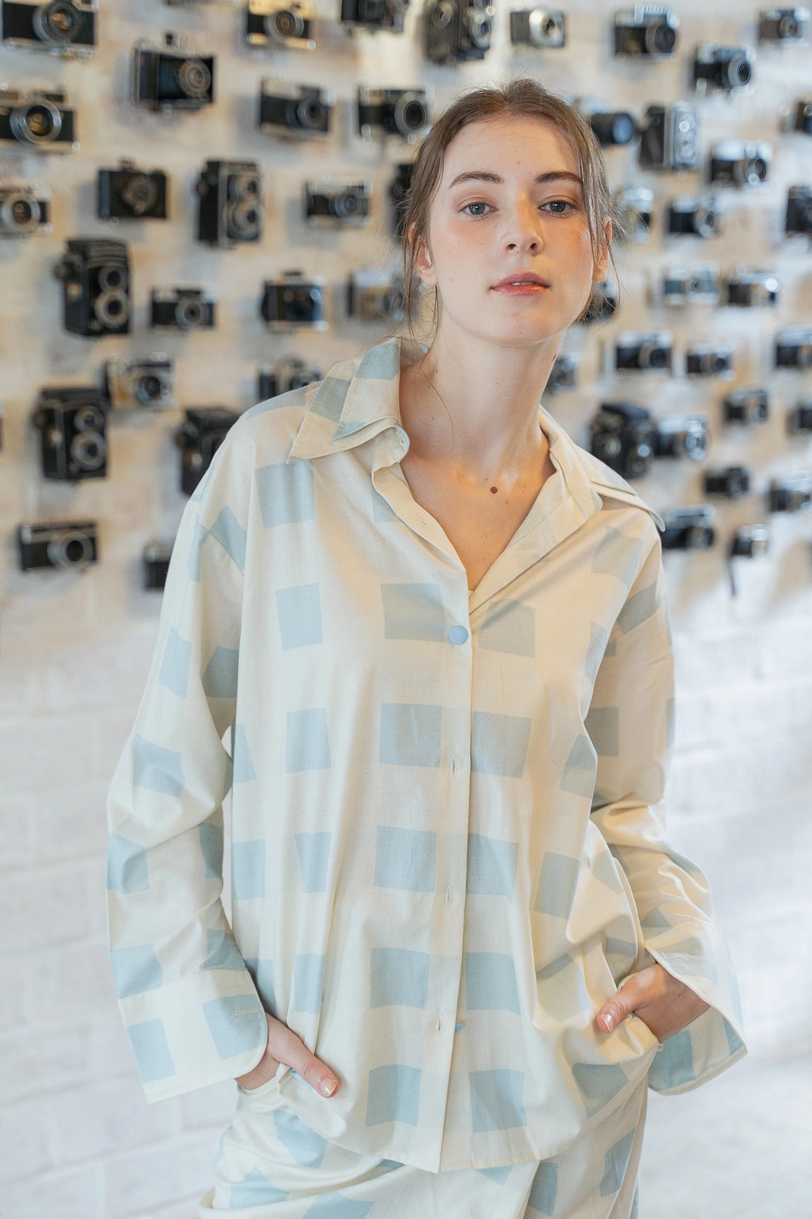 POYA cream blue check shirt and pants, camera wall