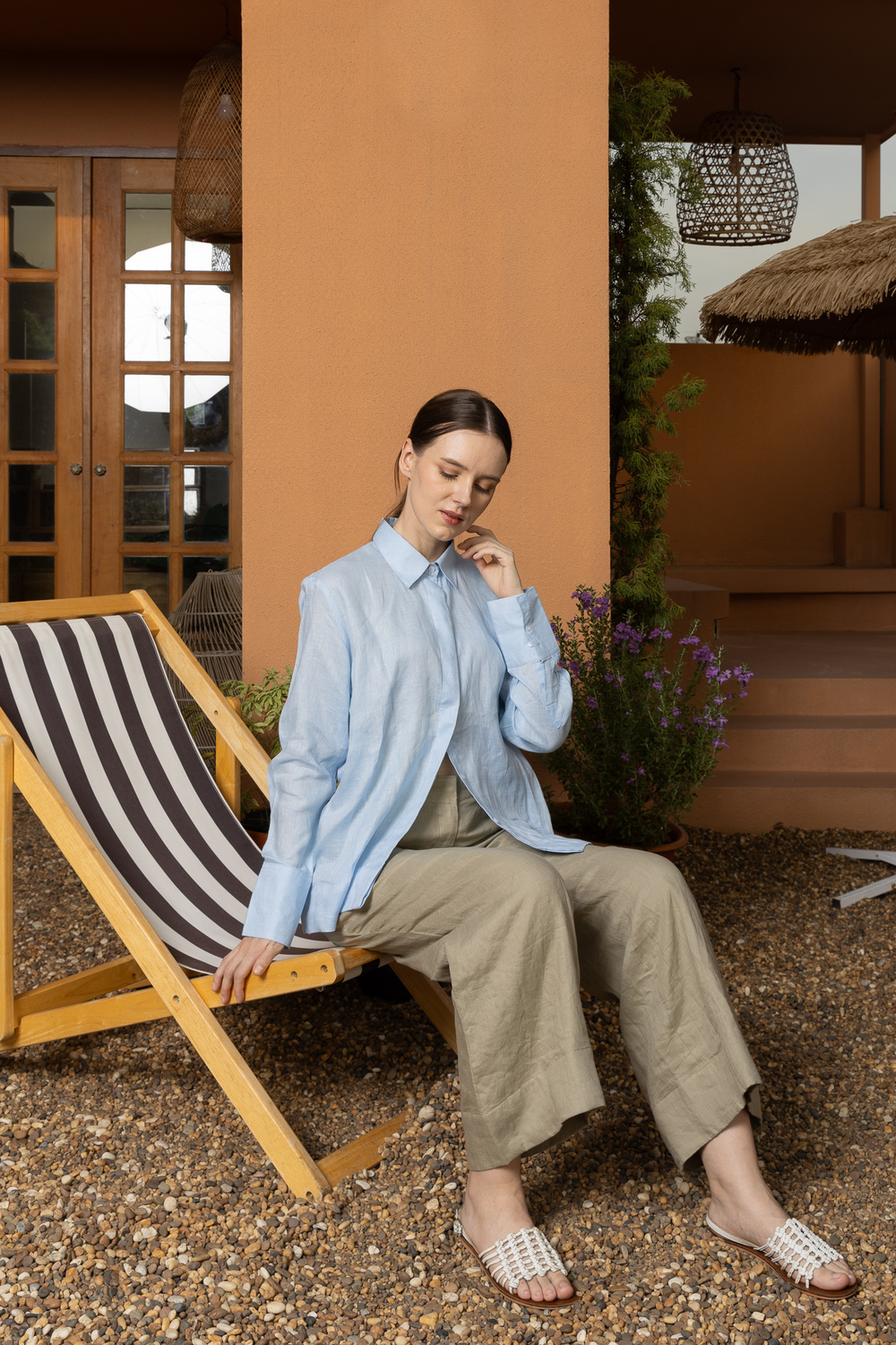 POYA Old Money Collection — sky-blue Belgian linen shirt with olive linen wide-leg trousers, styled outdoors in Bangkok